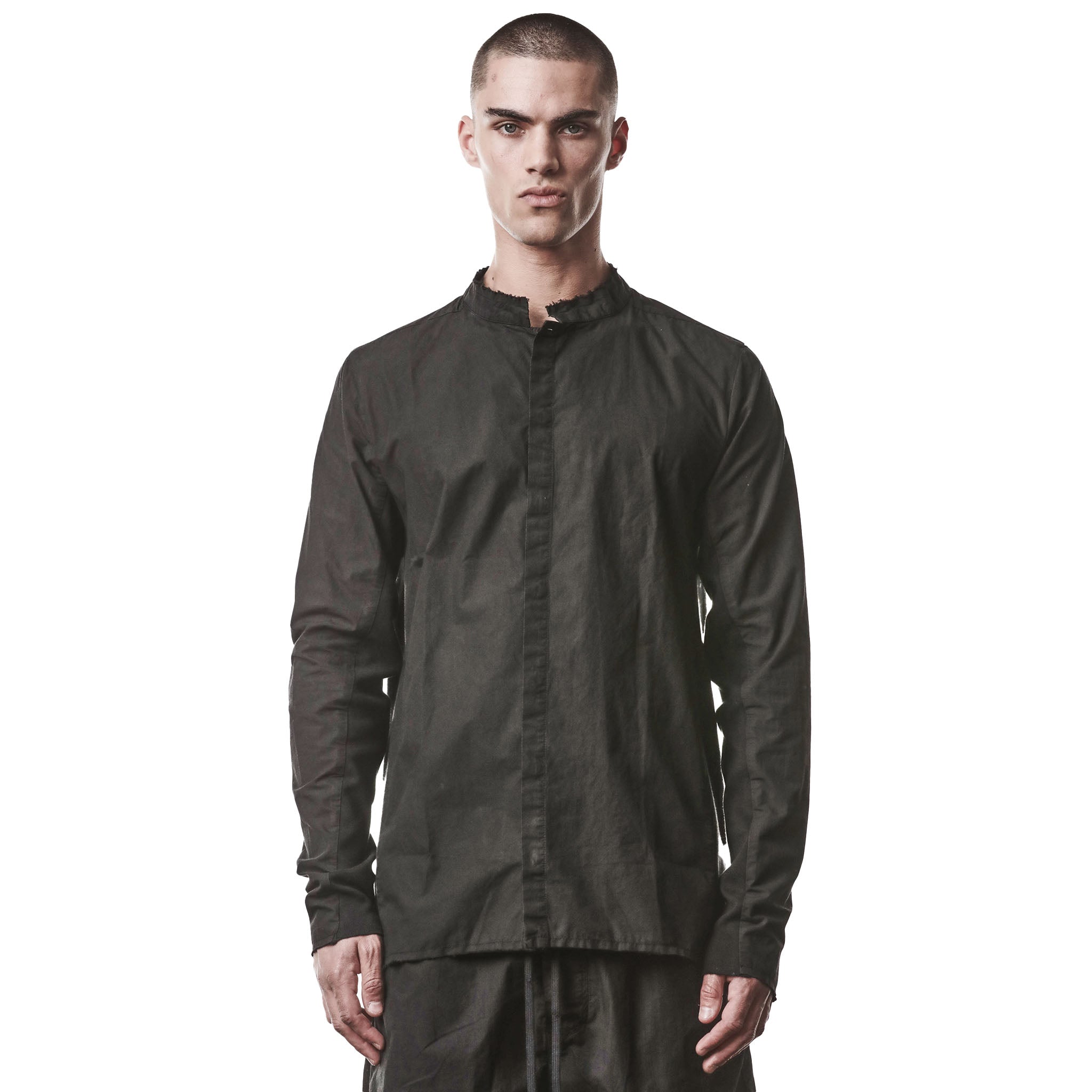 Man wearing a black, unique button up shirt on a white background